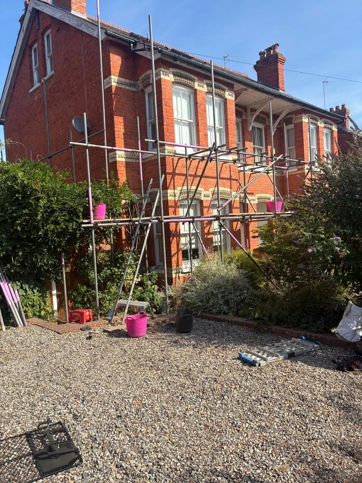 Domestic scaffold built around planted garden borders in Henley-on-Thames