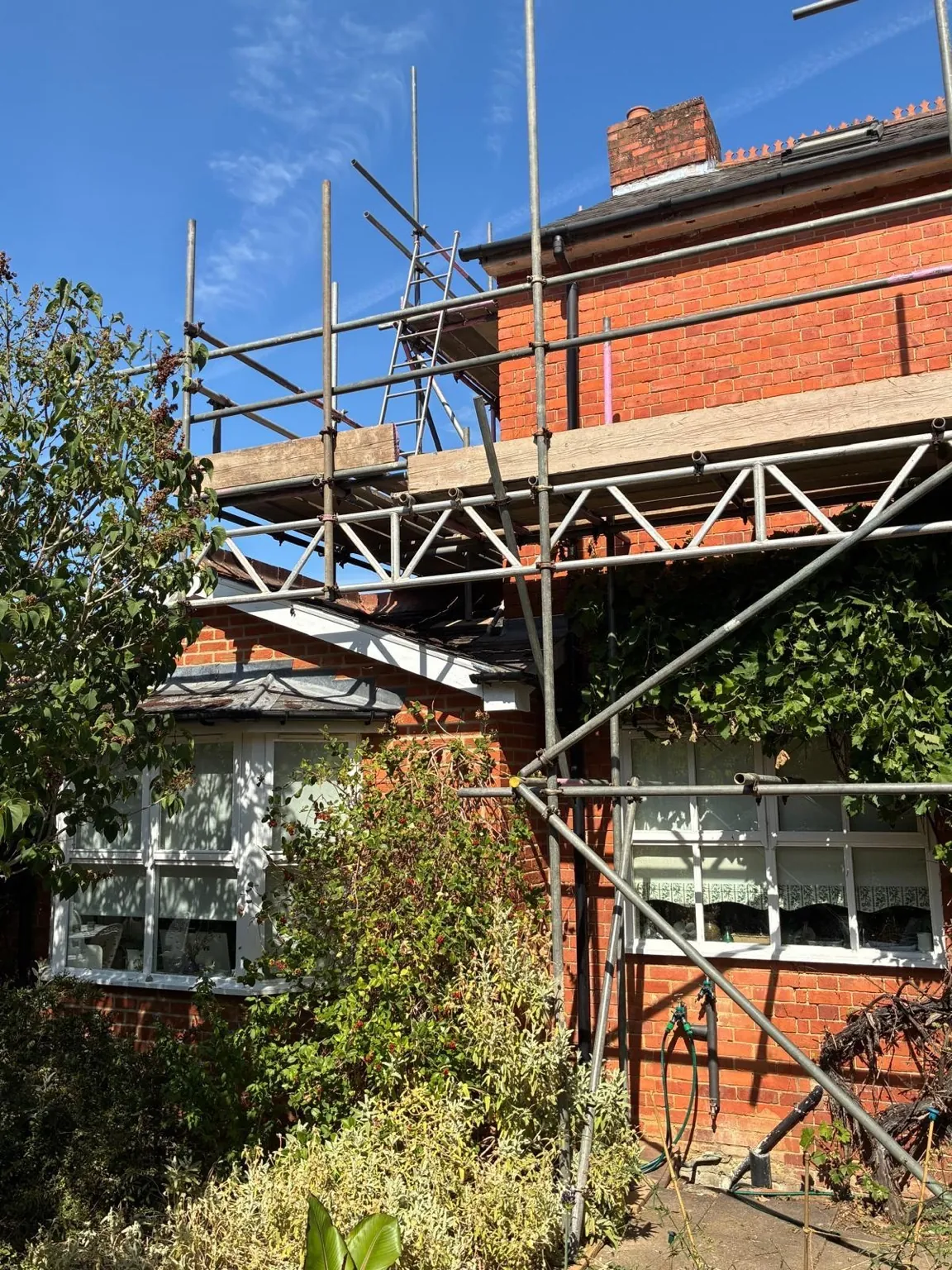 Aluminium lattice beam spanning a lower roof section at the rear of the property