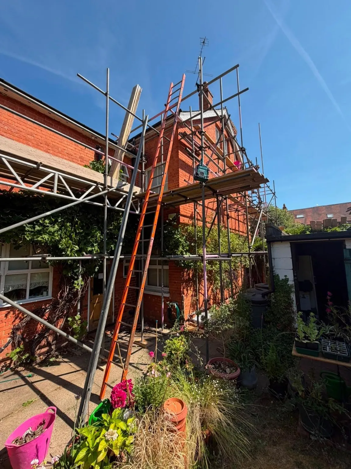 Scaffold built through a restricted courtyard area at the rear of the property