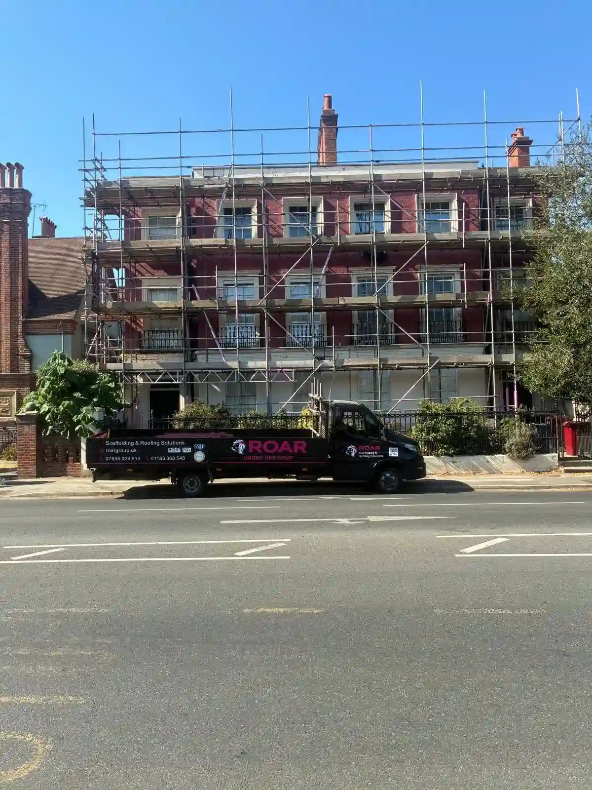 Roar Scaffolding vehicle outside a historic period building in Reading with a full-height scaffold across the front elevation