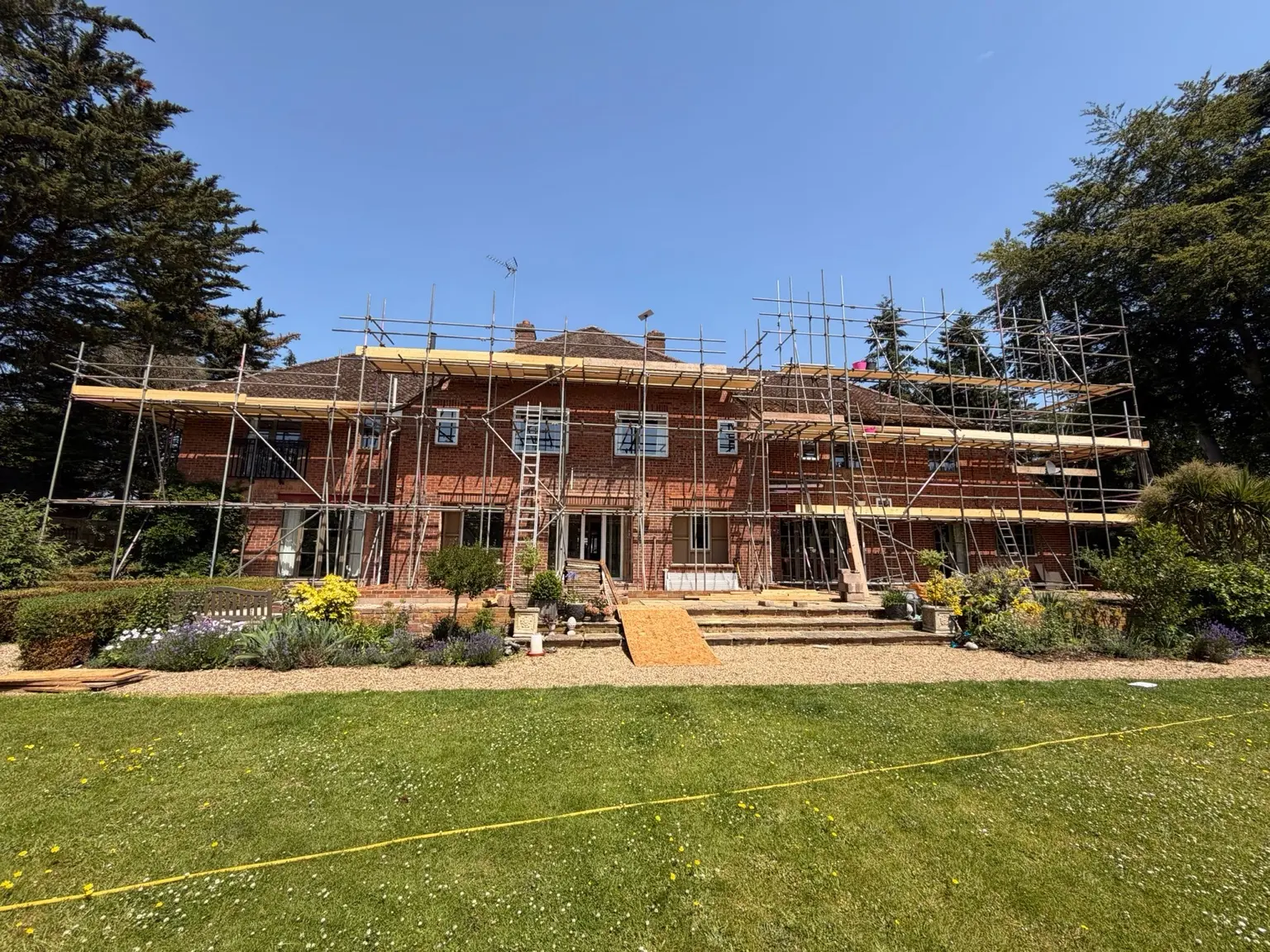 Wide view of multi-lift scaffolding across a large property in Medmenham, Buckinghamshire