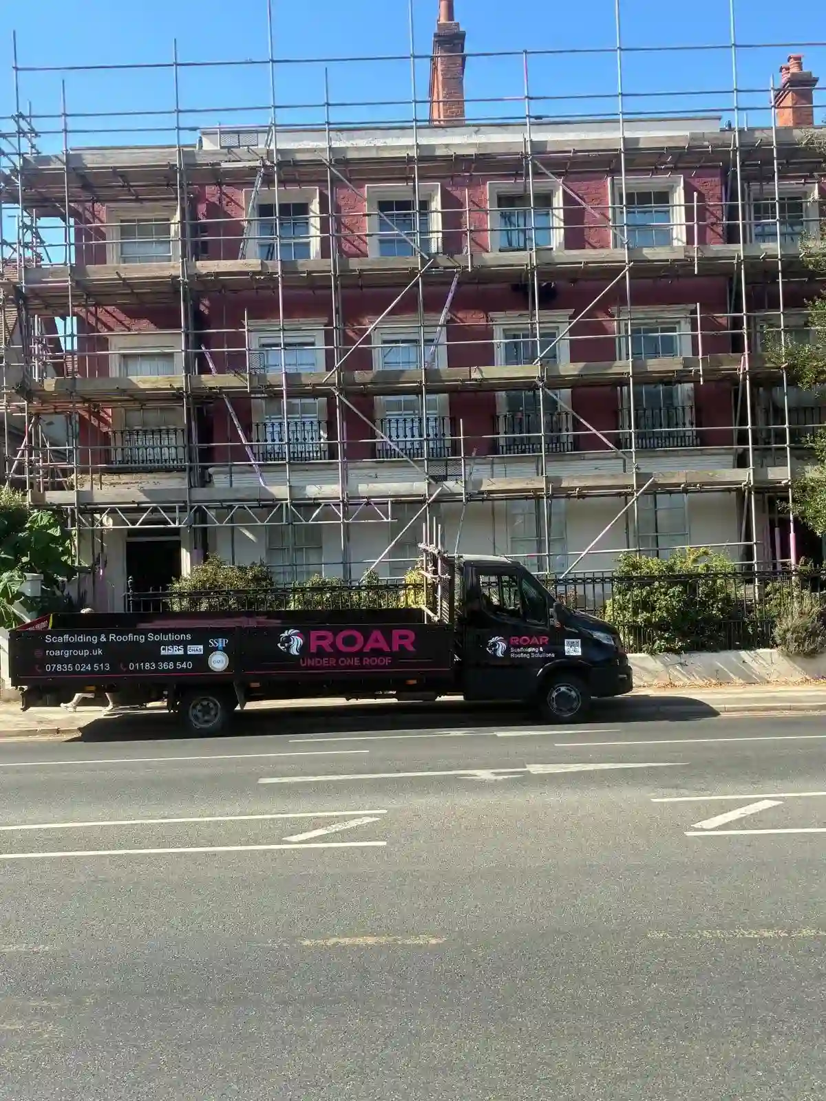 Multiple boarded working lifts stacked across a historic property in Reading