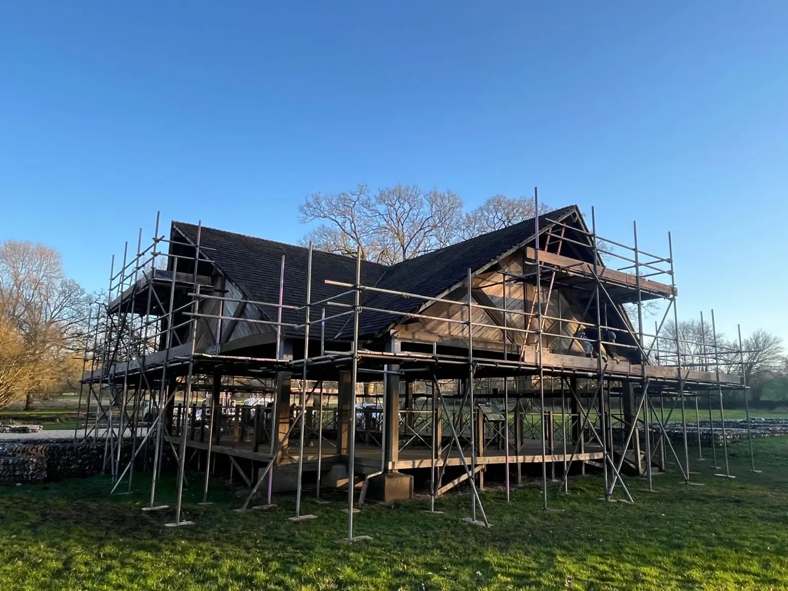 Three-quarter view of boarded scaffold lifts around the Littlecote Roman Villa protective pavilion