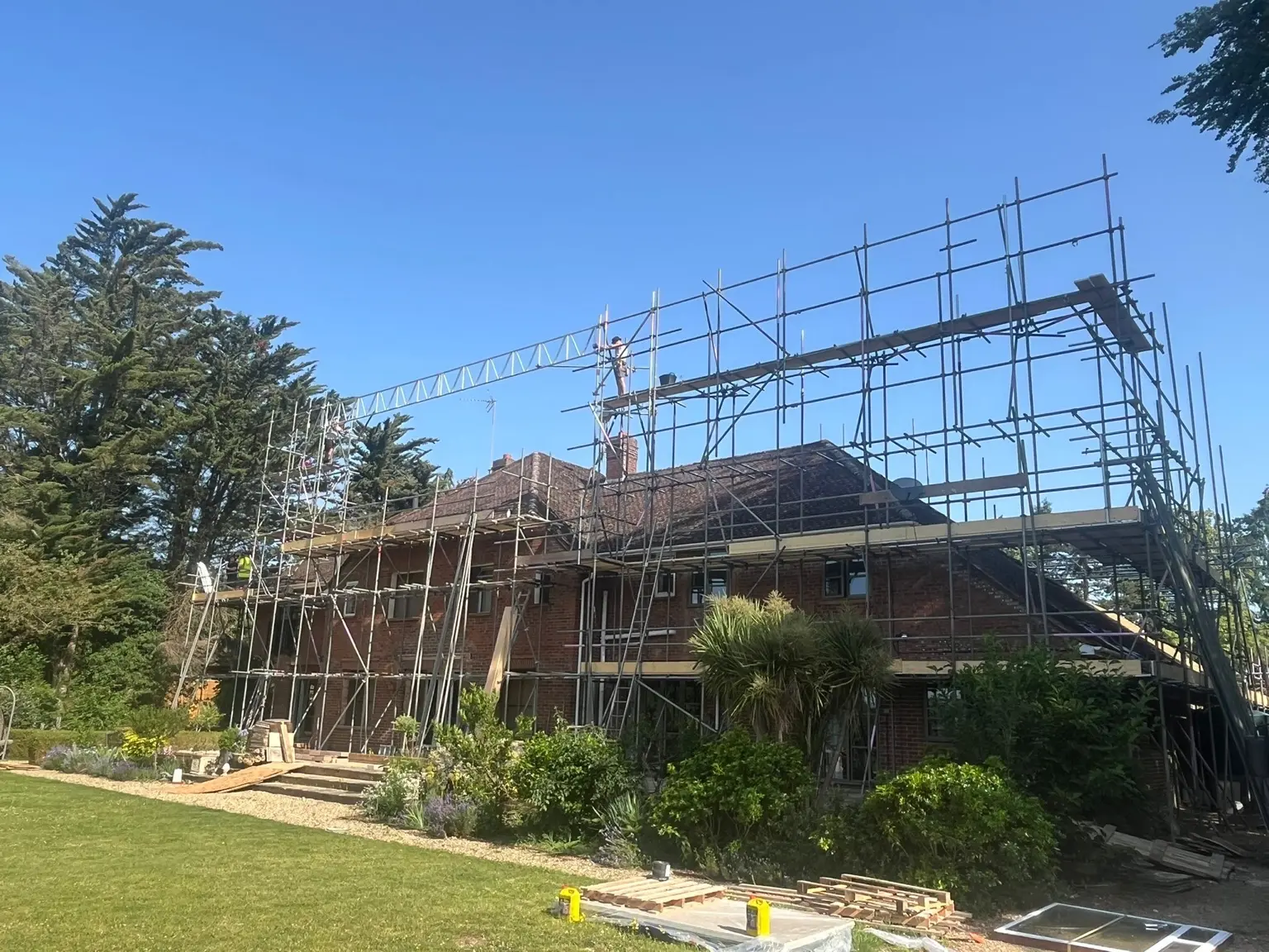 Multi-level scaffold with beamed upper sections around a Medmenham renovation