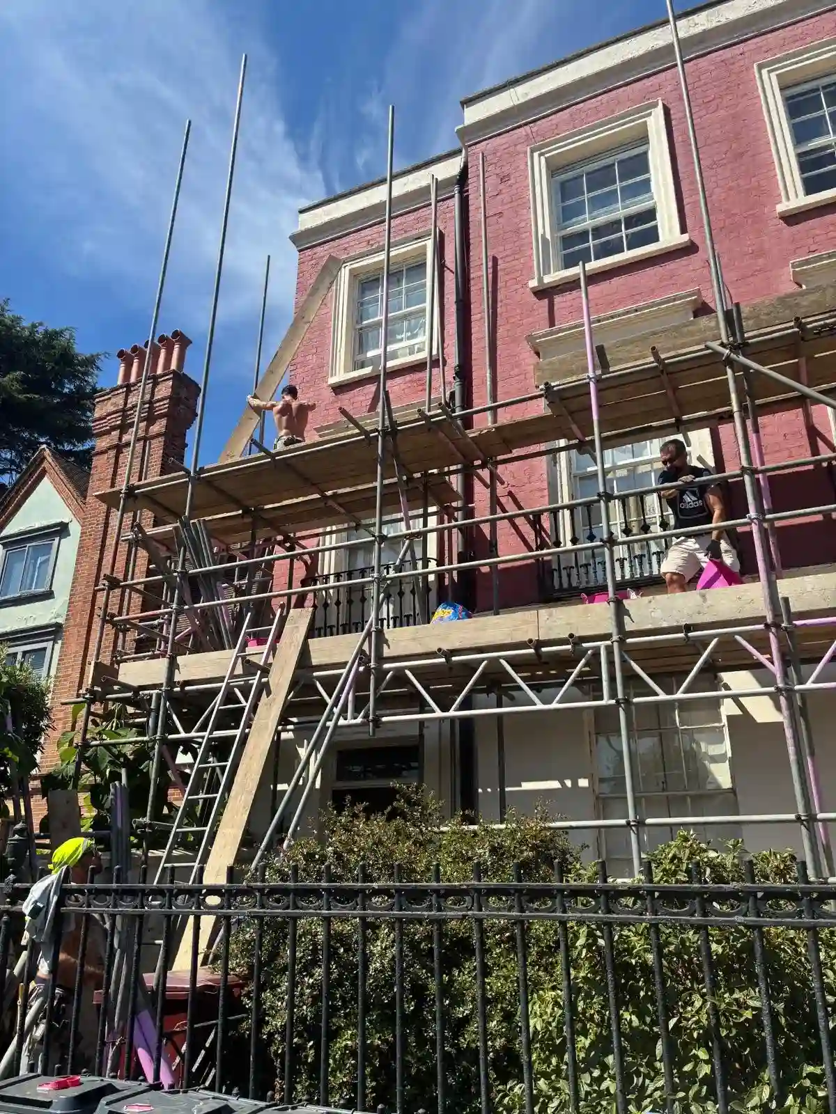 Aluminium lattice beam bridging the basement lightwell behind the boundary railings