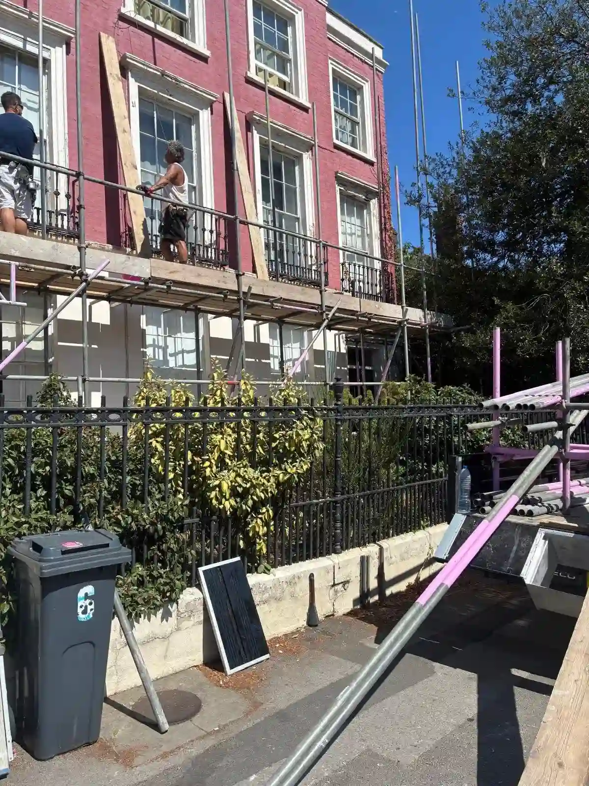 Contractors working on the lower boarded lift behind the front railings in Reading