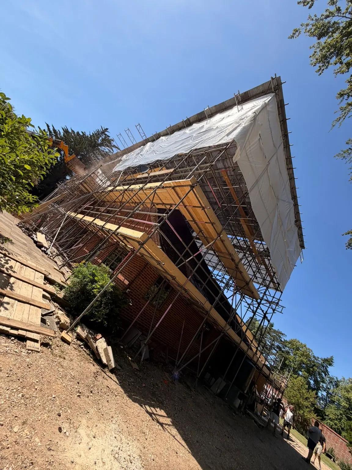 High-level scaffold and weather-protection structure during a major property renovation