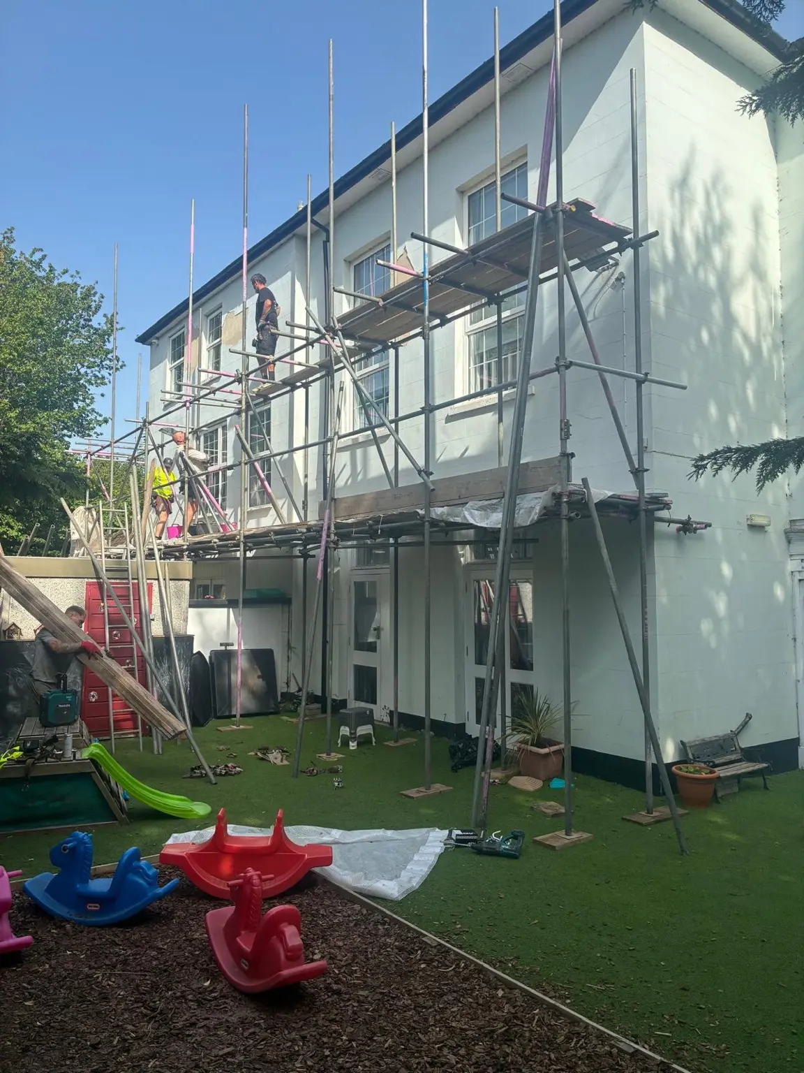 Tube-and-fitting scaffold under construction at a Newbury nursery
